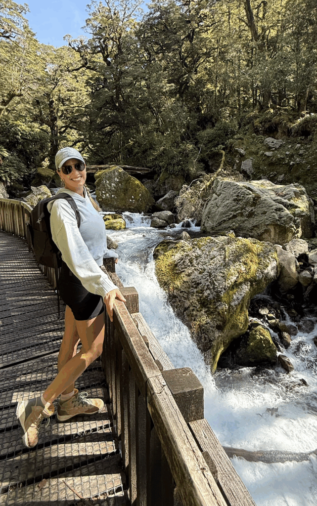 Lightweight hiking outfit for summer adventure travel in New Zealand including light jacket and trail shorts