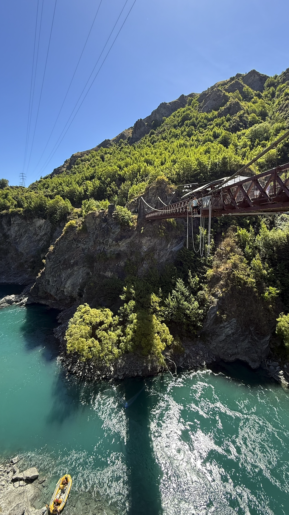 Bungee jumping from bridge into blue water in Queenstown New Zealand