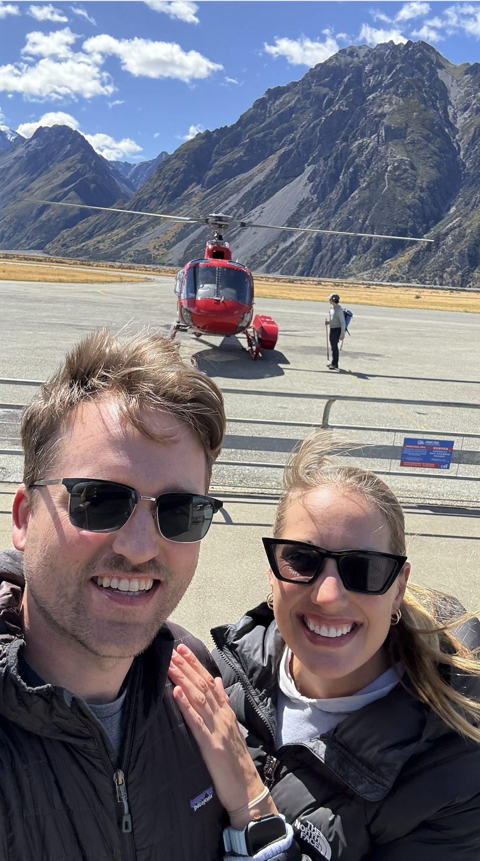 Couple boarding helicopter in Mt. Cook New Zealand to heli hike Tasman glacier