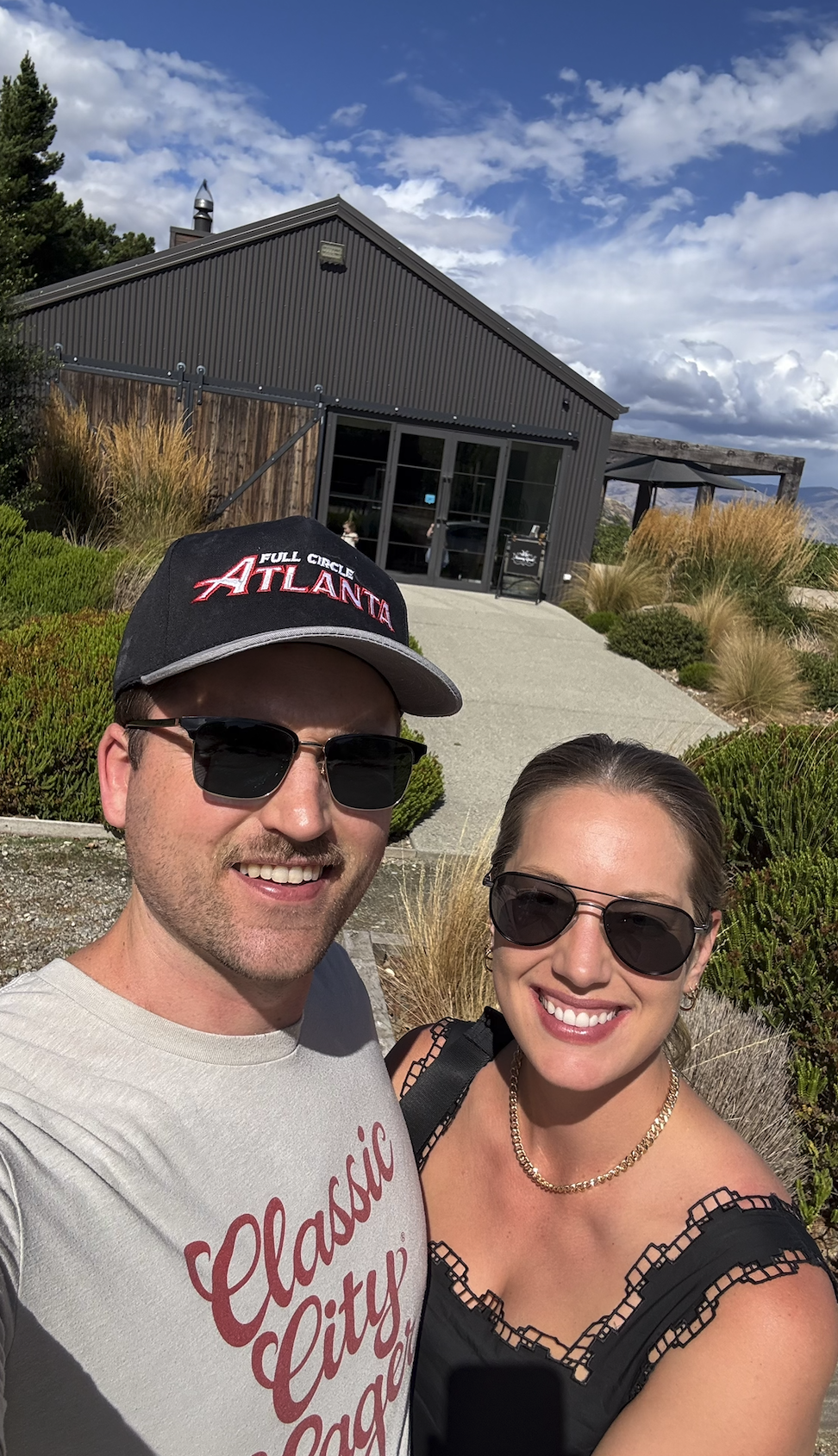 couple in front of a winery in wanaka new zealand
