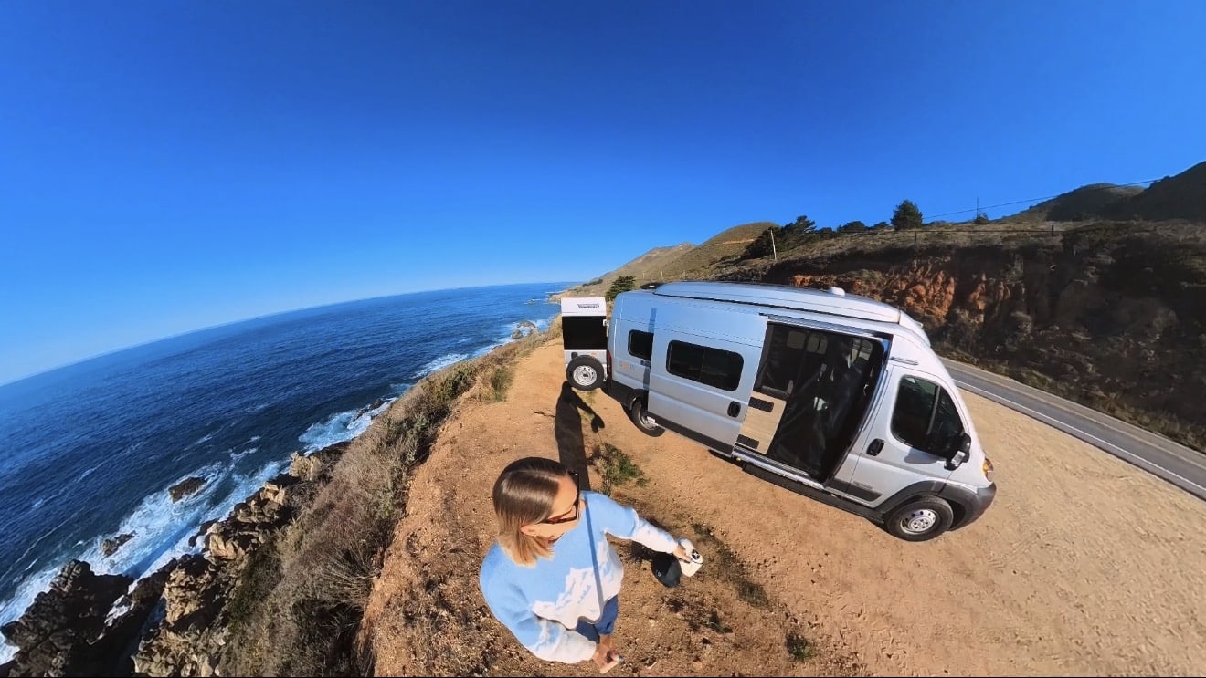 woman with a campervan on a highway 1 road trip in california