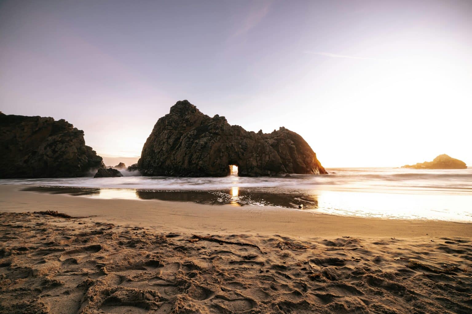 purple sand beach in big sur california at sunset
