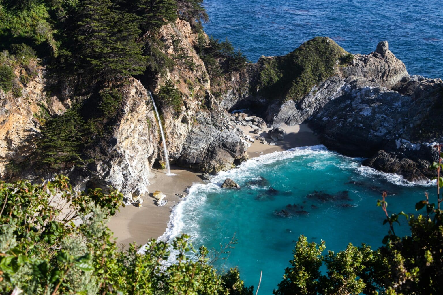mcway falls, a tidal waterfall on the big sur coast of the pacific coast highway 1